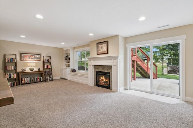 2021 Andrew Charles Dr NW, Cedar Rapids, IA 52405 - living room featuring carpet floors, recessed lighting, plenty of natural light, and a glass covered fireplace