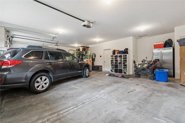 2021 Andrew Charles Dr NW, Cedar Rapids, IA 52405 - garage with stainless steel fridge with ice dispenser and a garage door opener