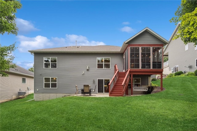 2021 Andrew Charles Dr NW, Cedar Rapids, IA 52405 - rear view of house featuring a sunroom, a yard, a patio, and stairs