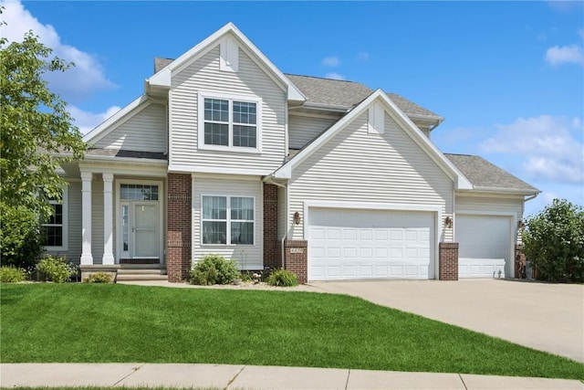 4420 Spring Meadow Pl NE, Cedar Rapids, IA 52411 - view of front of house featuring brick siding, a garage, concrete driveway, and a front lawn