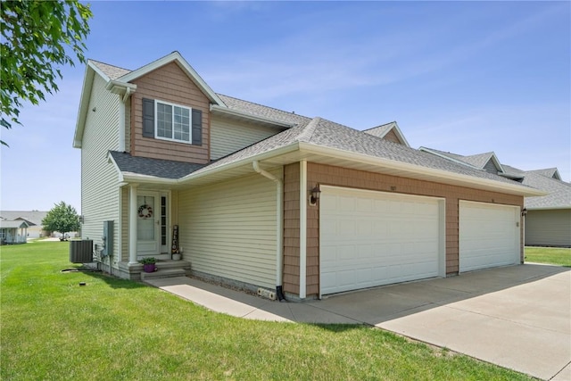 1019 Acacia Dr NE, Cedar Rapids, IA 52402 - view of front of house featuring a shingled roof, a garage, a front yard, and concrete driveway