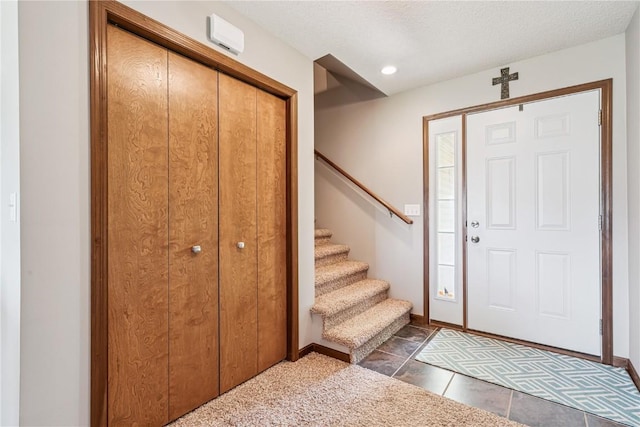 1019 Acacia Dr NE, Cedar Rapids, IA 52402 - tiled foyer featuring stairs and a textured ceiling