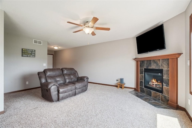 1019 Acacia Dr NE, Cedar Rapids, IA 52402 - living area with a ceiling fan, carpet flooring, and a tile fireplace