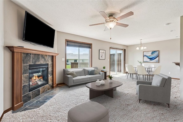 1019 Acacia Dr NE, Cedar Rapids, IA 52402 - carpeted living area with a fireplace, a textured ceiling, ceiling fan, and a chandelier