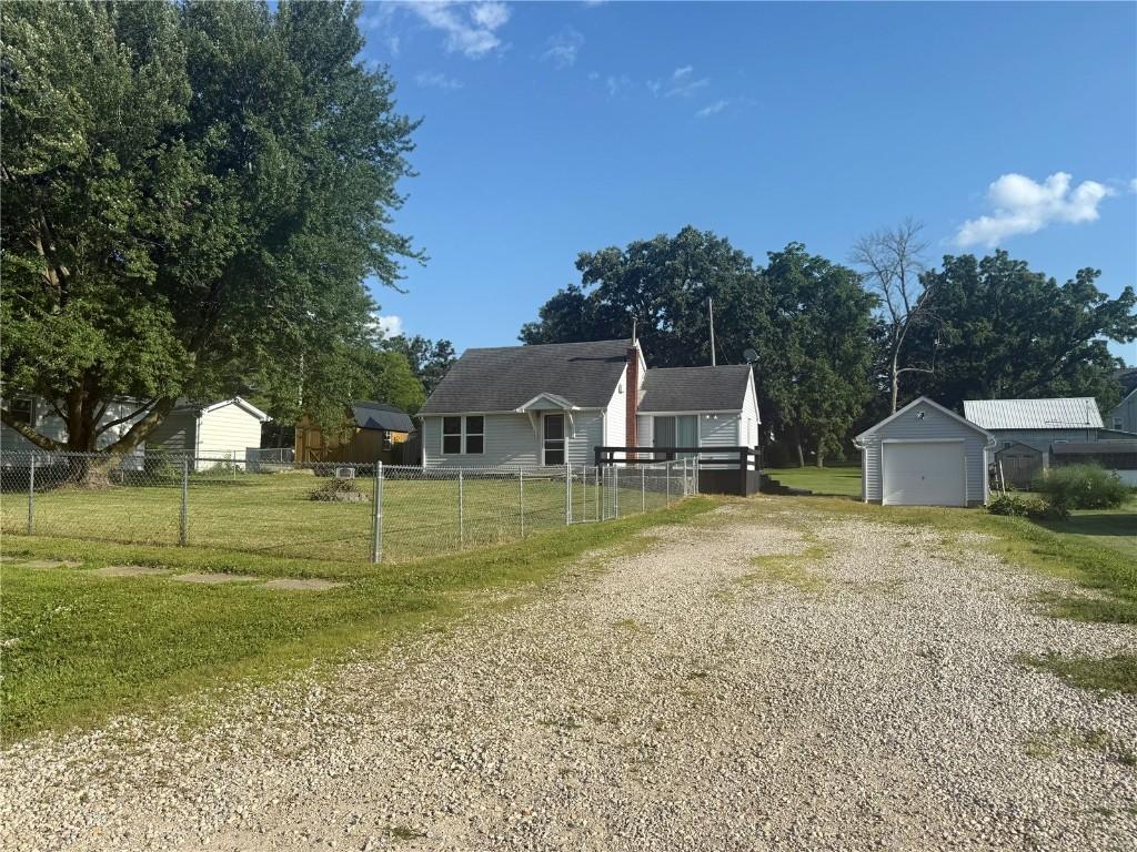 113 E Vinton St, Coggon, IA 52218 - bungalow-style house with a garage, driveway, and an outdoor structure