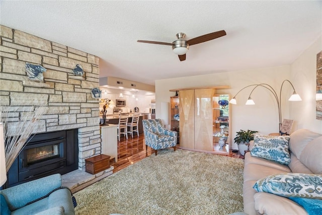1580 Matterhorn Dr NE, Cedar Rapids, IA 52402 - living area featuring a ceiling fan, wood finished floors, and a fireplace