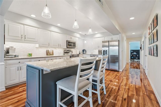 1580 Matterhorn Dr NE, Cedar Rapids, IA 52402 - kitchen featuring appliances with stainless steel finishes, decorative backsplash, white cabinetry, and recessed lighting