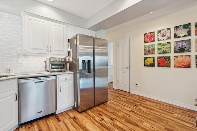 1580 Matterhorn Dr NE, Cedar Rapids, IA 52402 - kitchen with appliances with stainless steel finishes, light wood finished floors, and white cabinets