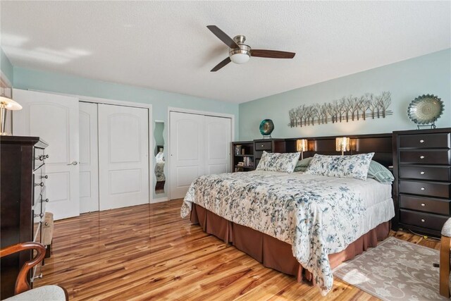 1580 Matterhorn Dr NE, Cedar Rapids, IA 52402 - bedroom featuring two closets, wood finished floors, and a ceiling fan