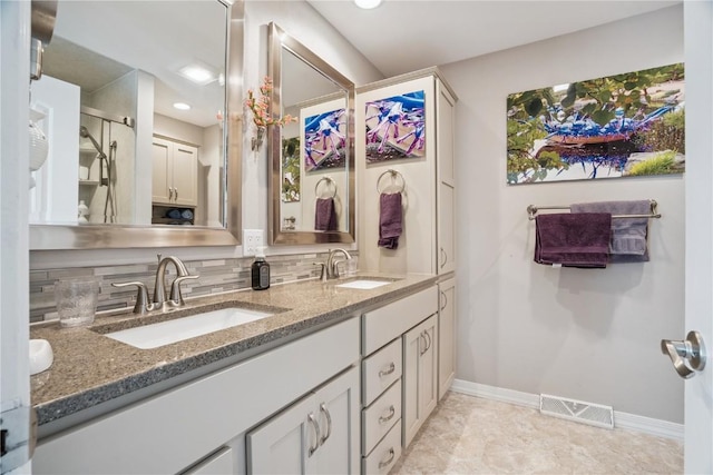1580 Matterhorn Dr NE, Cedar Rapids, IA 52402 - bathroom featuring double vanity, decorative backsplash, and recessed lighting