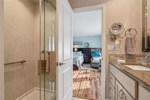1580 Matterhorn Dr NE, Cedar Rapids, IA 52402 - ensuite bathroom with vanity, a shower stall, and wood finished floors