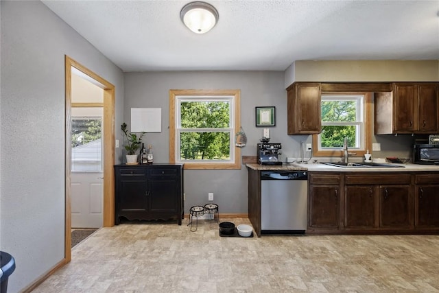 105 E Clark St, Hiawatha, IA 52233 - kitchen with stainless steel dishwasher, plenty of natural light, black microwave, and dark brown cabinets
