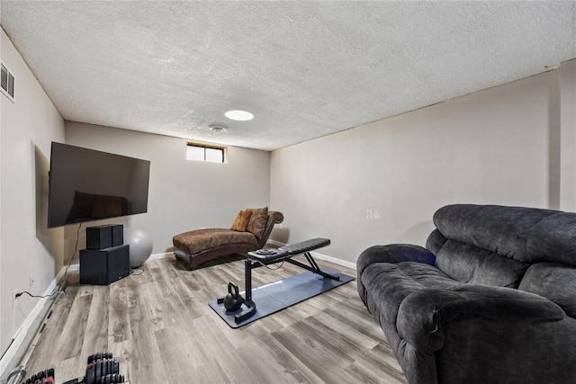 105 E Clark St, Hiawatha, IA 52233 - exercise room featuring wood finished floors and a textured ceiling