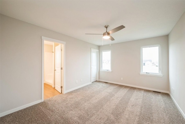 6188 Cope Dr, Marion, IA 52302 - unfurnished bedroom featuring light carpet, connected bathroom, and ceiling fan