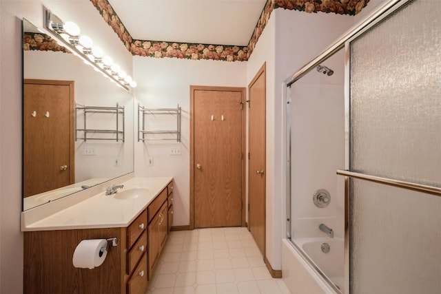 1641 Greens Way Ct, Cedar Rapids, IA 52402 - bathroom with tile patterned floors, vanity, and bath / shower combo with glass door