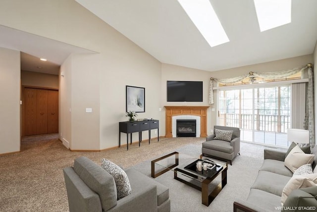 1641 Greens Way Ct, Cedar Rapids, IA 52402 - carpeted living room featuring high vaulted ceiling, a glass covered fireplace, and a skylight