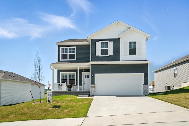 717 E Bear Dr, Tiffin, IA 52340 - craftsman inspired home featuring a porch, a garage, a front lawn, concrete driveway, and stone siding