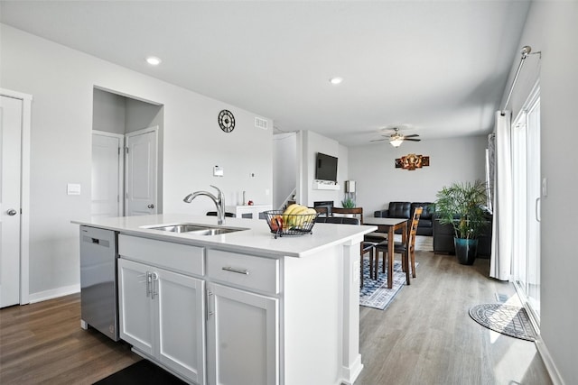 717 E Bear Dr, Tiffin, IA 52340 - kitchen with dishwasher, ceiling fan, wood finished floors, light countertops, and an island with sink