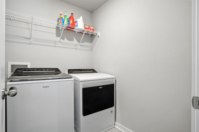 717 E Bear Dr, Tiffin, IA 52340 - washroom featuring washer and clothes dryer and baseboards
