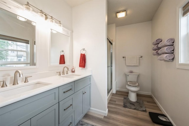 4405 Westchester Dr Unit B, Cedar Rapids, IA 52402 - full bathroom featuring double vanity, wood finished floors, and an enclosed shower