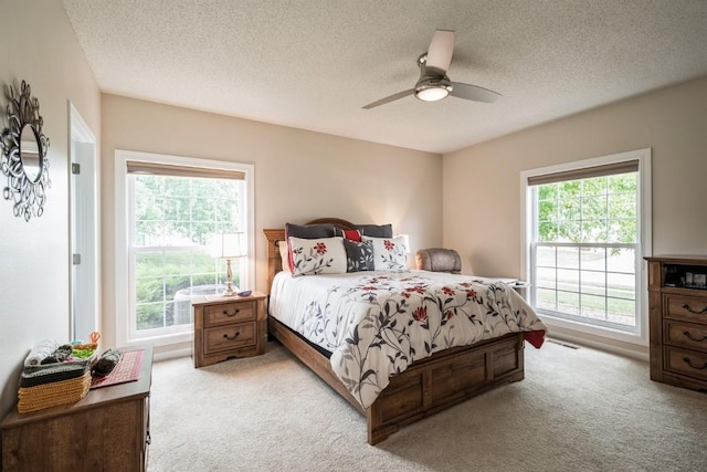 4405 Westchester Dr Unit B, Cedar Rapids, IA 52402 - bedroom featuring light colored carpet, a textured ceiling, and a ceiling fan