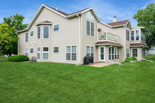 4405 Westchester Dr Unit B, Cedar Rapids, IA 52402 - rear view of house with a balcony, a yard, and a chimney