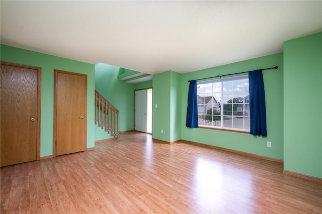 6514 Fox Run Dr SW, Cedar Rapids, IA 52404 - unfurnished living room with wood finished floors and stairway