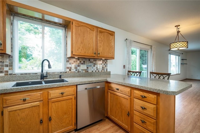 6514 Fox Run Dr SW, Cedar Rapids, IA 52404 - kitchen featuring stainless steel dishwasher, a peninsula, light wood-style flooring, and backsplash