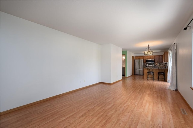 6514 Fox Run Dr SW, Cedar Rapids, IA 52404 - unfurnished living room with light wood-style floors and baseboards