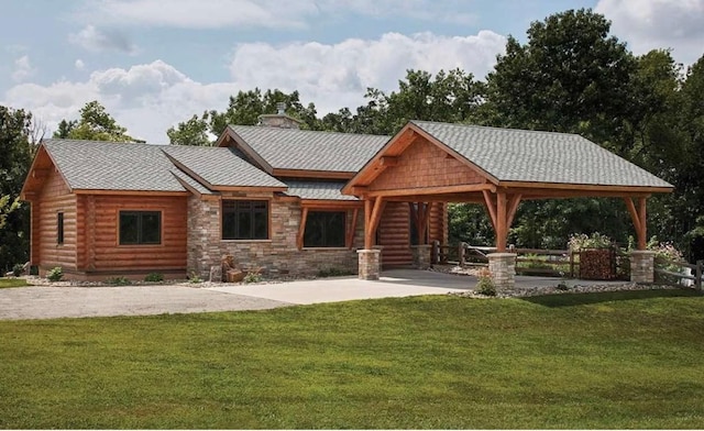 140 Falcon Dr, Montezuma, IA 50171 - surrounding community featuring a lawn, concrete driveway, and a patio