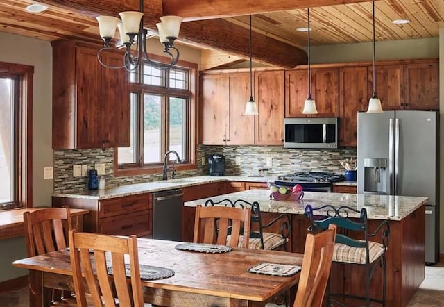 140 Falcon Dr, Montezuma, IA 50171 - kitchen with stainless steel appliances, a wooden ceiling with exposed beams, tasteful backsplash, a kitchen island, and light stone countertops