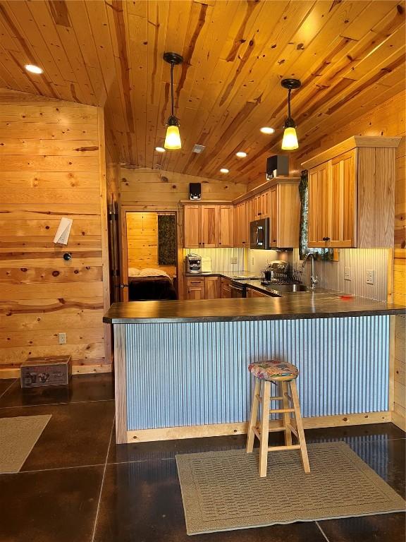 140 Falcon Dr, Montezuma, IA 50171 - kitchen featuring black microwave, wooden ceiling, a peninsula, dark countertops, and wooden walls