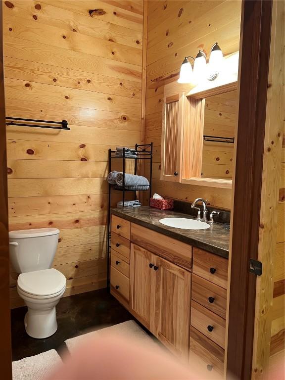 140 Falcon Dr, Montezuma, IA 50171 - bathroom with vanity and wood walls