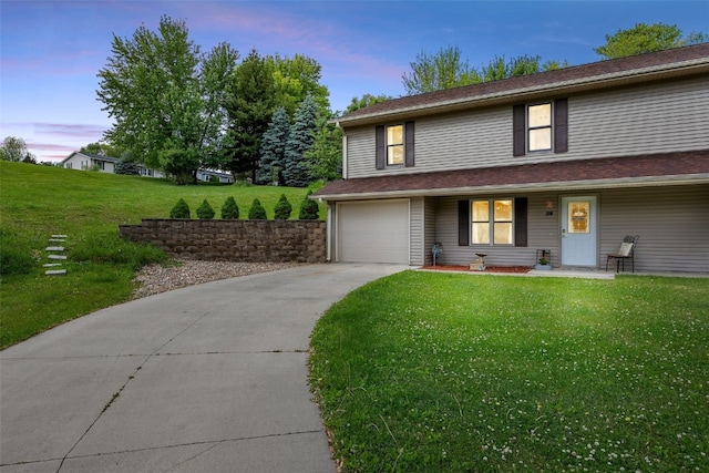 114 Therese Ave, Anamosa, IA 52205 - view of front of house featuring a garage, a yard, concrete driveway, and a porch