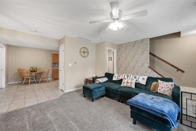 114 Therese Ave, Anamosa, IA 52205 - carpeted living area featuring a ceiling fan and tile patterned flooring