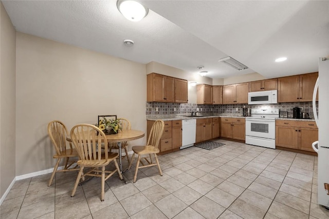 114 Therese Ave, Anamosa, IA 52205 - kitchen with white appliances, tasteful backsplash, light countertops, and light tile patterned flooring