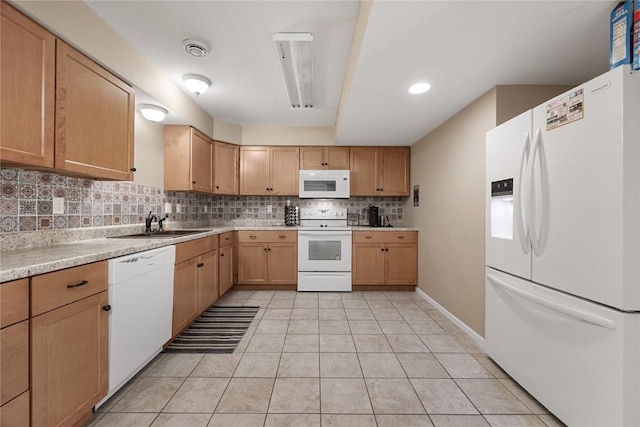 114 Therese Ave, Anamosa, IA 52205 - kitchen with white appliances, decorative backsplash, light countertops, light tile patterned floors, and light brown cabinets
