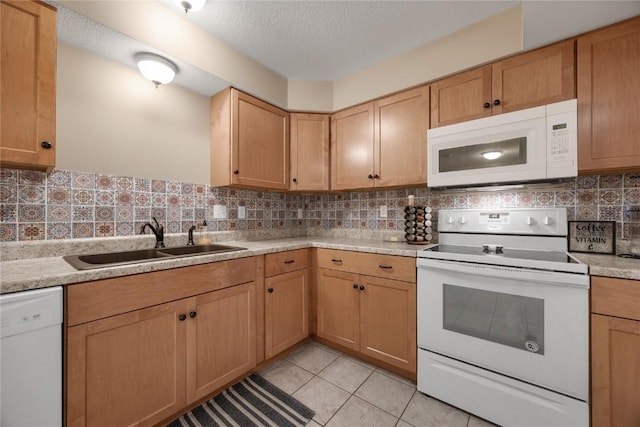 114 Therese Ave, Anamosa, IA 52205 - kitchen featuring white appliances, light countertops, decorative backsplash, a textured ceiling, and light tile patterned floors