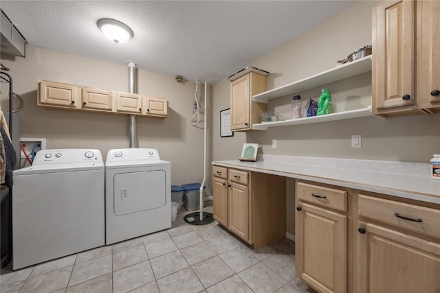 114 Therese Ave, Anamosa, IA 52205 - laundry room with washing machine and dryer, cabinet space, light tile patterned floors, and a textured ceiling