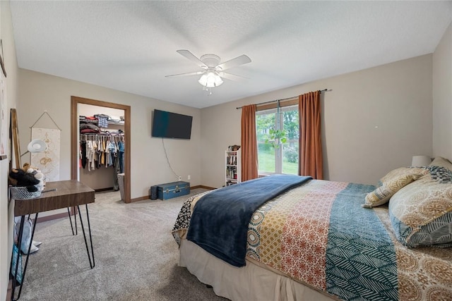 114 Therese Ave, Anamosa, IA 52205 - bedroom featuring light colored carpet, a closet, a walk in closet, and ceiling fan
