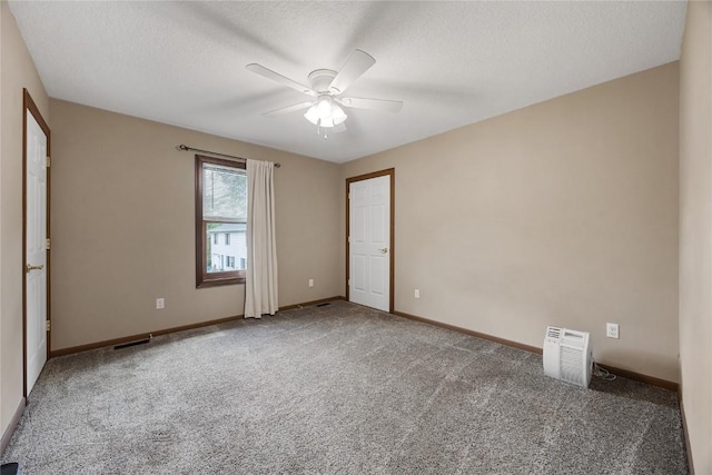 114 Therese Ave, Anamosa, IA 52205 - spare room featuring carpet, a ceiling fan, and a textured ceiling