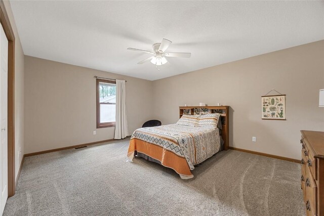 114 Therese Ave, Anamosa, IA 52205 - carpeted bedroom with baseboards and ceiling fan