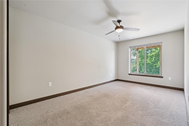713 Hillside Dr, Tiffin, IA 52340 - unfurnished room with light carpet and ceiling fan