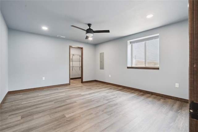 713 Hillside Dr, Tiffin, IA 52340 - spare room with electric panel, ceiling fan, light wood-type flooring, and recessed lighting