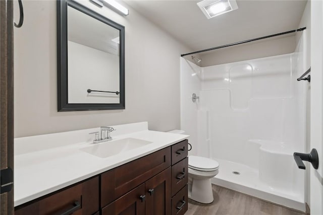 713 Hillside Dr, Tiffin, IA 52340 - bathroom with vanity, wood finished floors, and a shower
