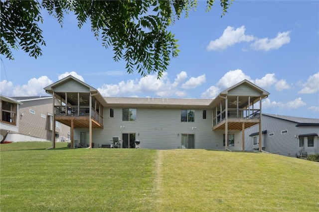 713 Hillside Dr, Tiffin, IA 52340 - rear view of property with ceiling fan, a sunroom, and a lawn