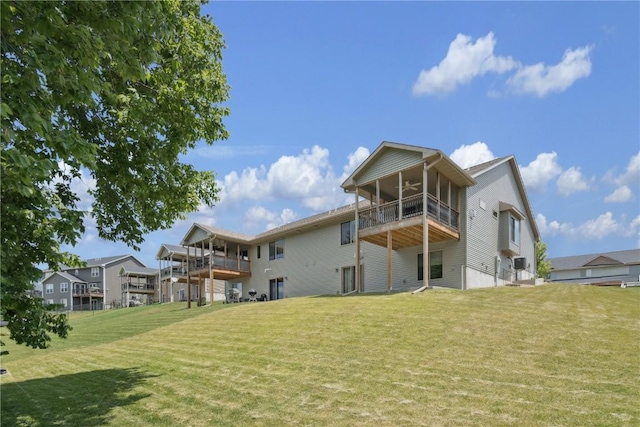 713 Hillside Dr, Tiffin, IA 52340 - rear view of property featuring a ceiling fan, a yard, a balcony, and a sunroom