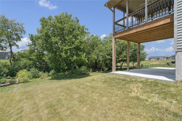 713 Hillside Dr, Tiffin, IA 52340 - view of green lawn featuring a deck and a patio