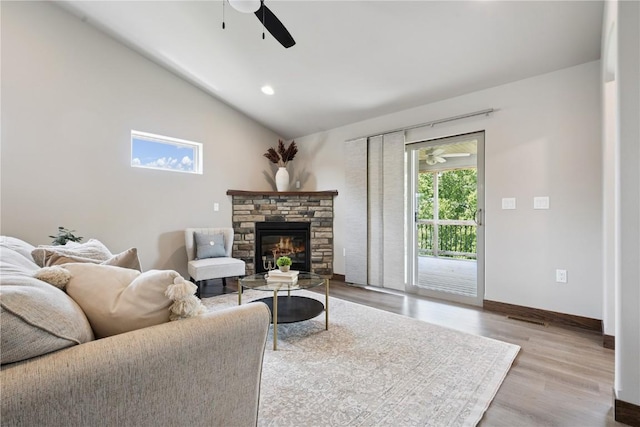 713 Hillside Dr, Tiffin, IA 52340 - living area featuring a ceiling fan, lofted ceiling, a stone fireplace, wood finished floors, and recessed lighting