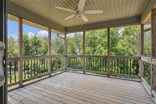 713 Hillside Dr, Tiffin, IA 52340 - unfurnished sunroom featuring ceiling fan and view of wooded area